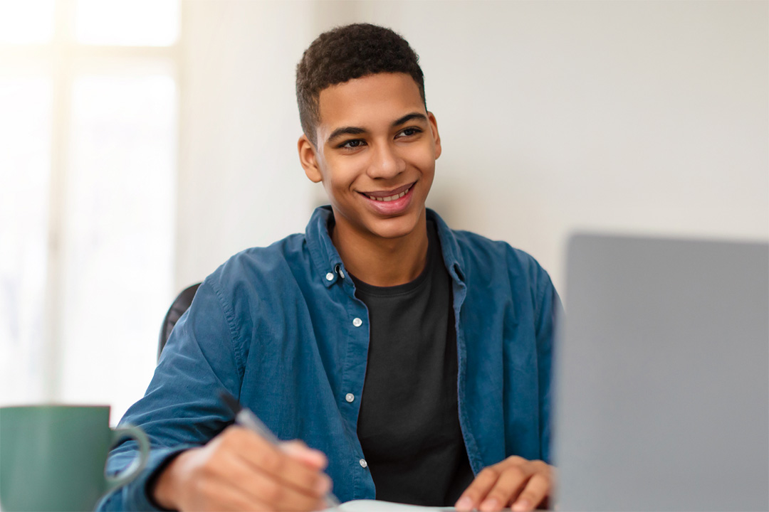 A nursing student at home on their laptop.