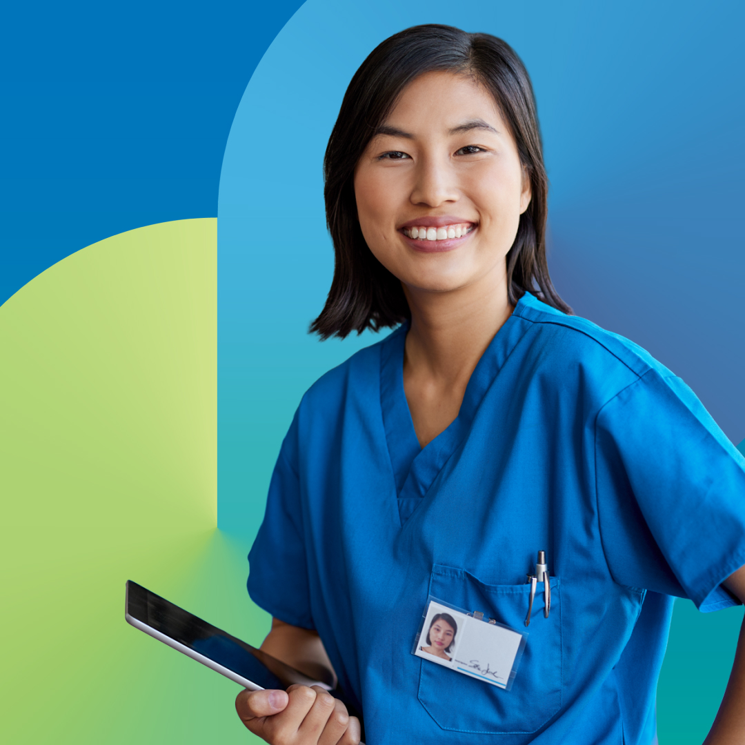 Portrait of smiling nurse looking at camera holding a tablet.