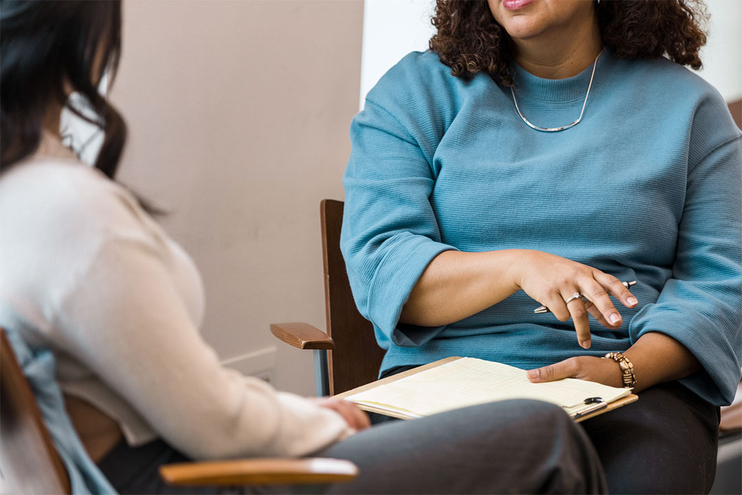A closeup of a one-on-one in-person counselling session.