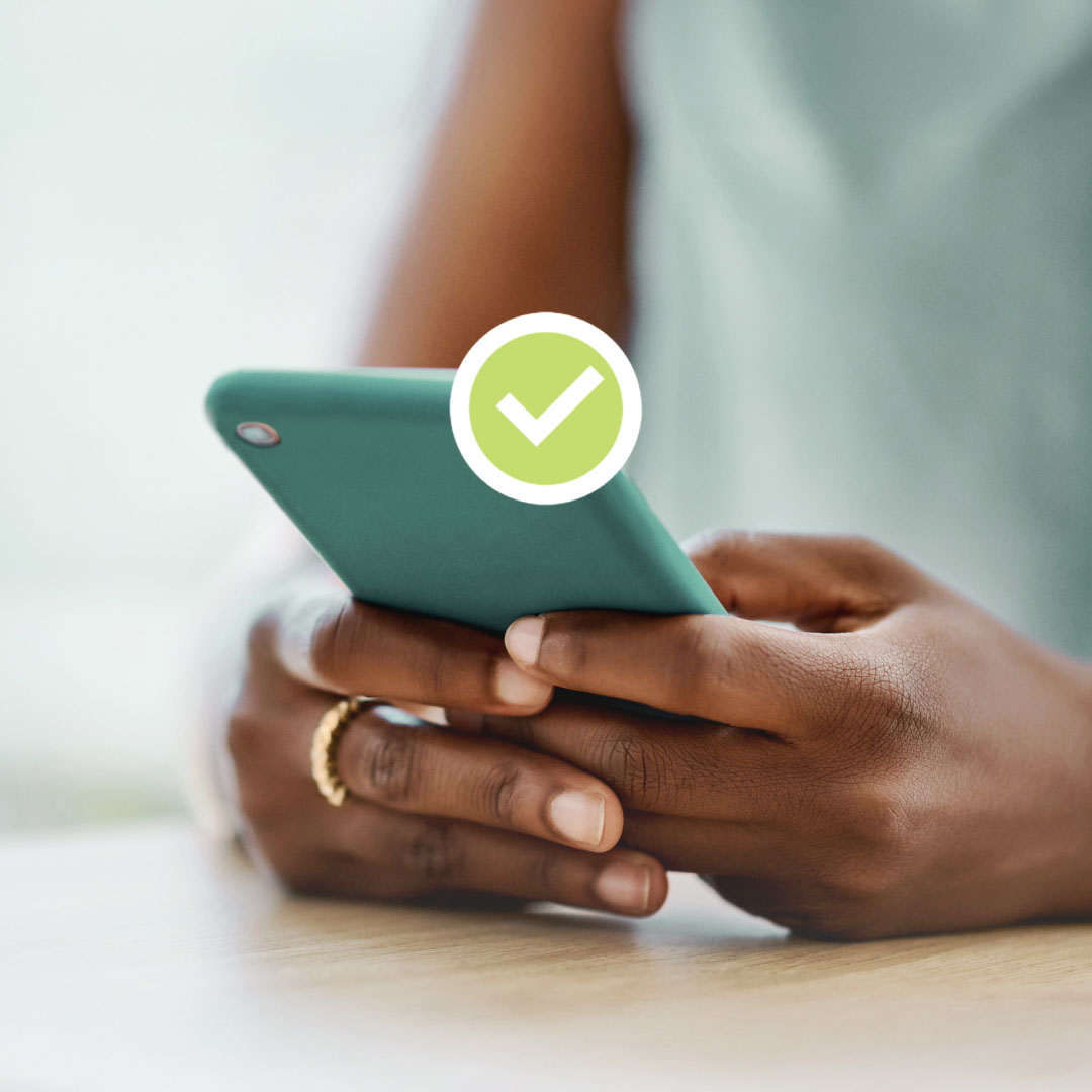 A woman holding a phone. A checkmark symbol overlaid on top.