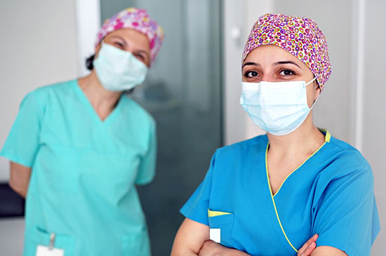 Image of two nurses wearing masks.