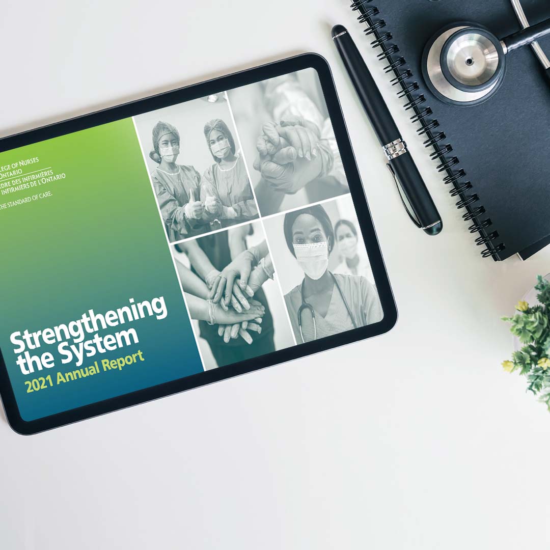 iPad on a table with nurses as a screen cover. Caption reads: Strengthening The System 2021 Annual Report